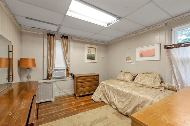 48 Carstairs Rd, Valley Stream, NY 11581 - bedroom with hardwood / wood-style floors, radiator, a drop ceiling, and cooling unit