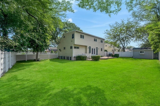 32 Clarkson Rd, Centereach, NY 11720 - rear view of property featuring a fenced backyard and an outbuilding
