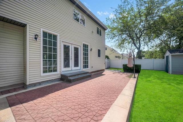 32 Clarkson Rd, Centereach, NY 11720 - fenced backyard with a patio, french doors, and a storage shed