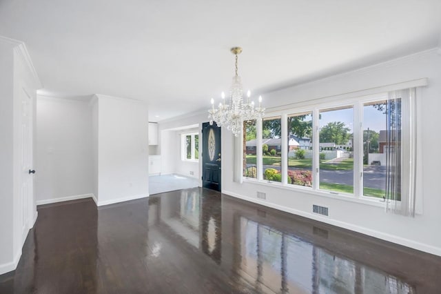 32 Clarkson Rd, Centereach, NY 11720 - spare room with dark wood finished floors, a chandelier, and ornamental molding