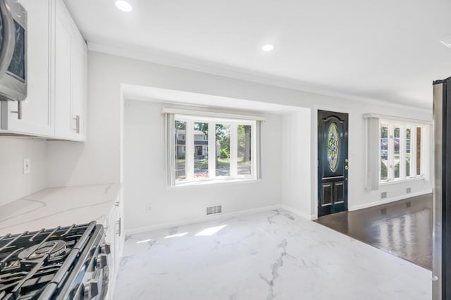 32 Clarkson Rd, Centereach, NY 11720 - kitchen featuring appliances with stainless steel finishes, crown molding, white cabinetry, light stone counters, and recessed lighting