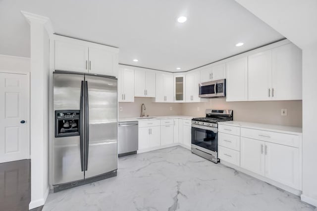 32 Clarkson Rd, Centereach, NY 11720 - kitchen with stainless steel appliances, recessed lighting, white cabinetry, light marble finish flooring, and light countertops