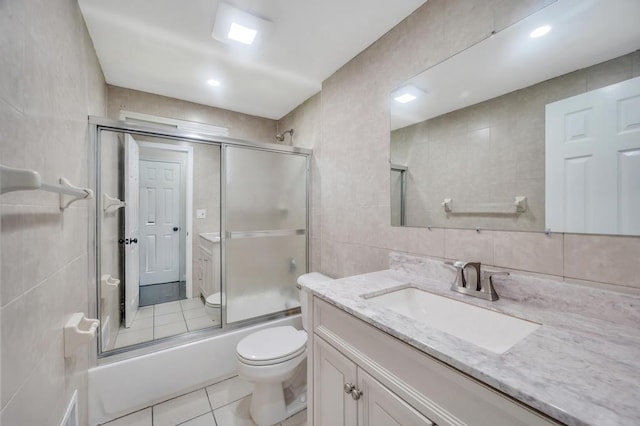 32 Clarkson Rd, Centereach, NY 11720 - full bath featuring tile walls, vanity, bath / shower combo with glass door, and tile patterned flooring