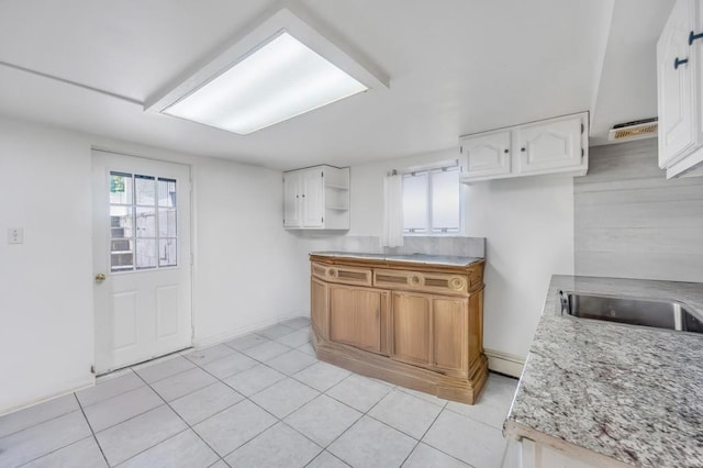32 Clarkson Rd, Centereach, NY 11720 - kitchen with open shelves, white cabinetry, light tile patterned floors, and light countertops