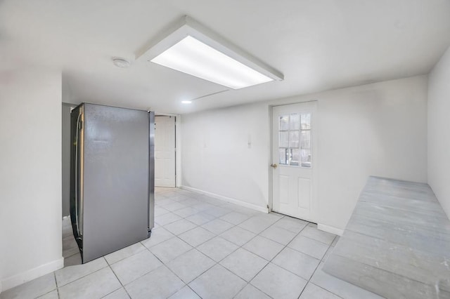 32 Clarkson Rd, Centereach, NY 11720 - below grade area featuring light tile patterned floors and baseboards