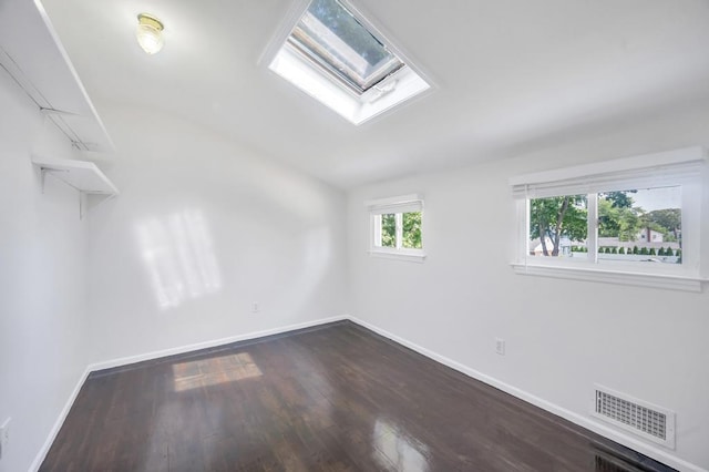 32 Clarkson Rd, Centereach, NY 11720 - empty room featuring a skylight, dark wood-type flooring, and vaulted ceiling