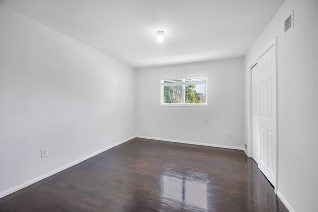 32 Clarkson Rd, Centereach, NY 11720 - unfurnished bedroom with dark wood finished floors and a closet