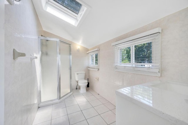 32 Clarkson Rd, Centereach, NY 11720 - bathroom with tile walls, tile patterned flooring, a stall shower, a skylight, and lofted ceiling