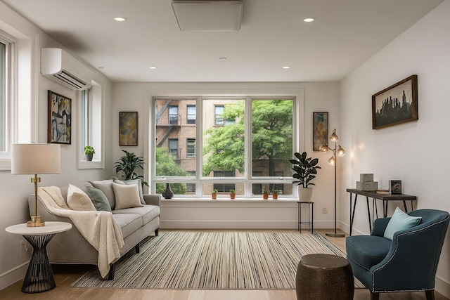 226 Hart St Unit 3B, Brooklyn, NY 11206 - living area with a wall unit AC, wood finished floors, and recessed lighting