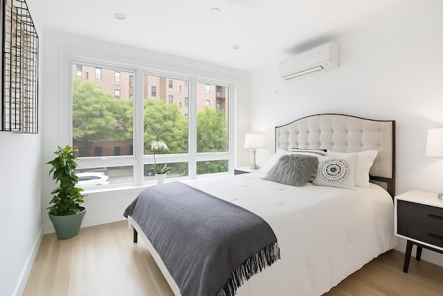 226 Hart St Unit 3B, Brooklyn, NY 11206 - bedroom featuring a wall mounted air conditioner and wood finished floors