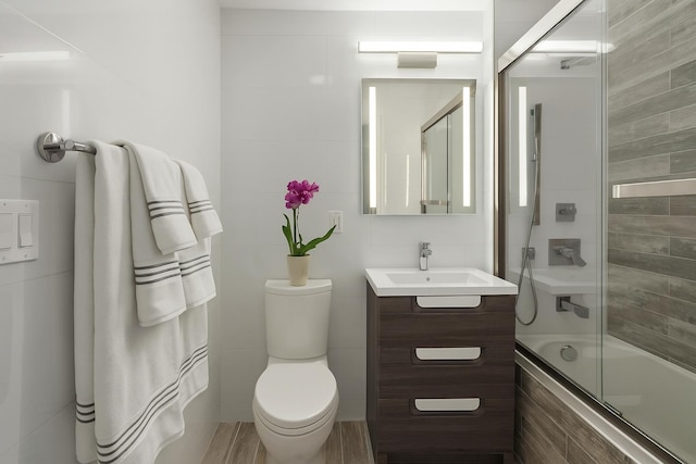 226 Hart St Unit 3B, Brooklyn, NY 11206 - full bath with tiled shower / bath combo, vanity, and tile walls