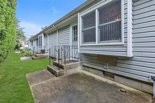 5 Primrose Ln, North Babylon, NY 11703 - view of property exterior featuring a lawn and a patio