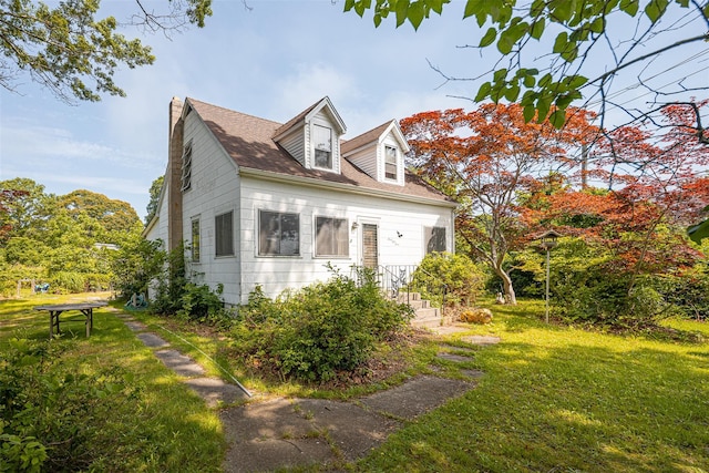 353 W Elm Rd, Mastic Beach, NY 11951 - view of front of home featuring a front yard and a chimney