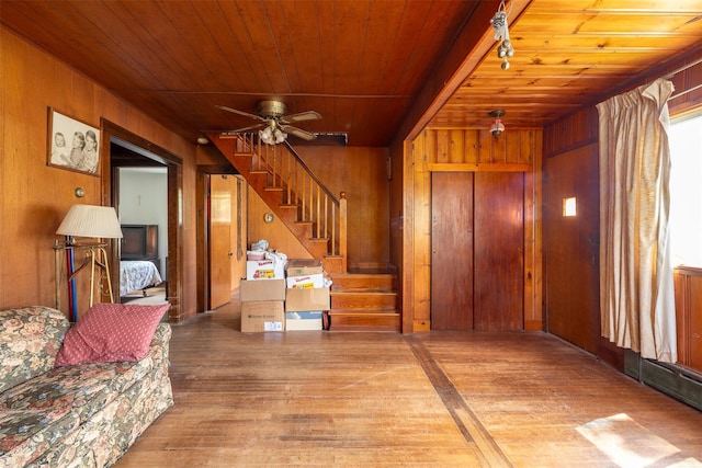 353 W Elm Rd, Mastic Beach, NY 11951 - unfurnished living room featuring wood ceiling, hardwood / wood-style floors, wood walls, stairs, and ceiling fan