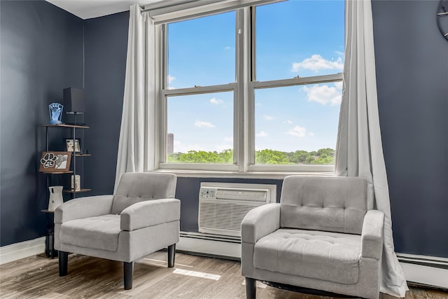5444 Little Neck Pkwy Unit 6C, Little Neck, NY 11362 - living area featuring a baseboard heating unit, baseboard heating, wood finished floors, and healthy amount of natural light