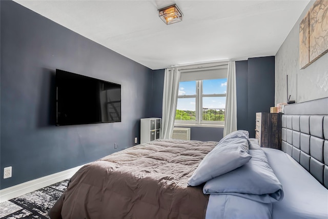 5444 Little Neck Pkwy Unit 6C, Little Neck, NY 11362 - bedroom with baseboards and a wall mounted air conditioner
