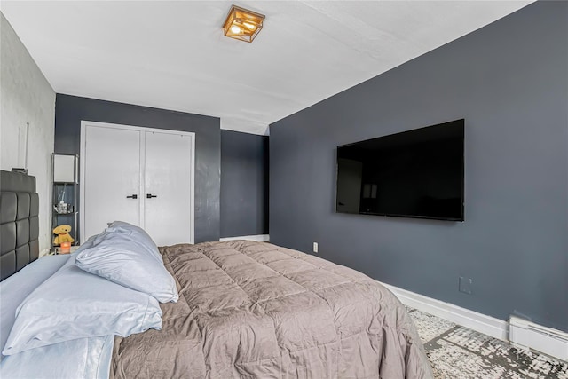 5444 Little Neck Pkwy Unit 6C, Little Neck, NY 11362 - bedroom featuring a baseboard heating unit and a closet