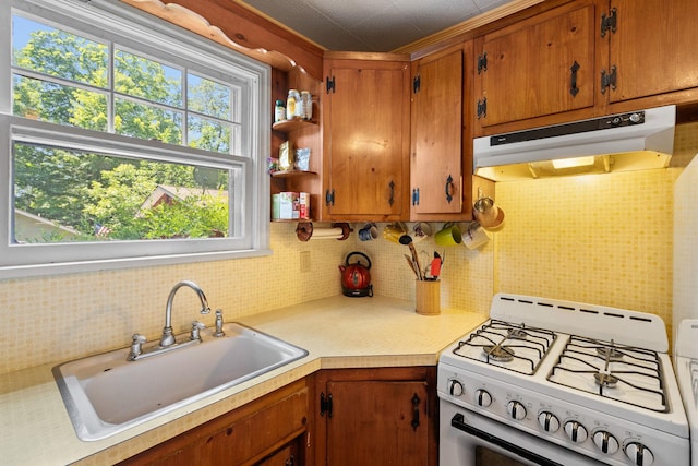 1467 Rte 292, Holmes, NY 12531 - kitchen featuring gas range gas stove, under cabinet range hood, backsplash, light countertops, and brown cabinets