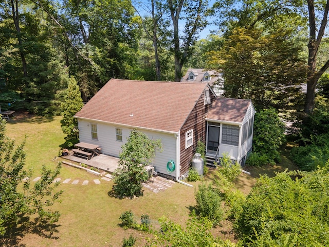 1467 Rte 292, Holmes, NY 12531 - view of side of home with a sunroom, a shingled roof, a yard, and a patio