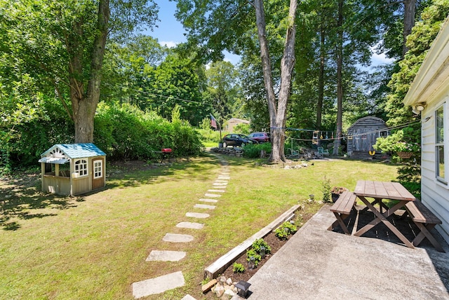 1467 Rte 292, Holmes, NY 12531 - view of green lawn featuring outdoor dining area, a patio, view of scattered trees, and a shed