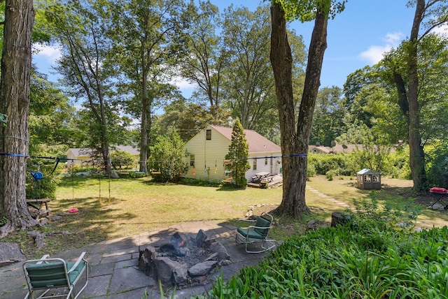 1467 Rte 292, Holmes, NY 12531 - view of green lawn featuring a fire pit, a patio, a shed, and view of wooded area
