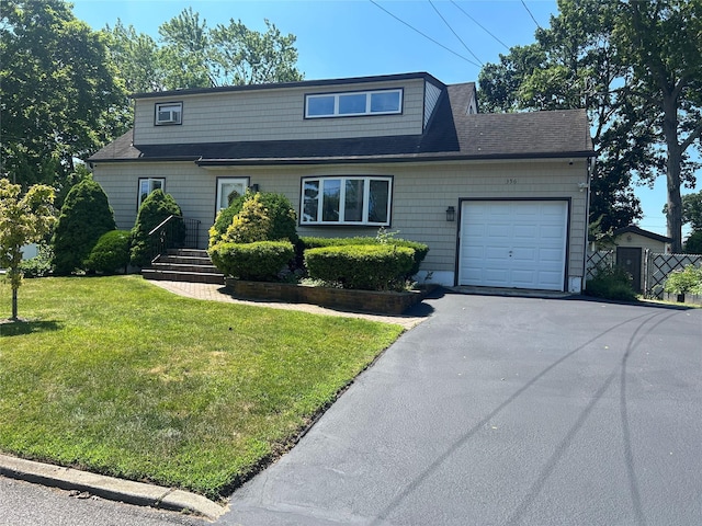 356 Montgomery Ave, West Babylon, NY 11704 - view of front of home featuring asphalt driveway and a garage