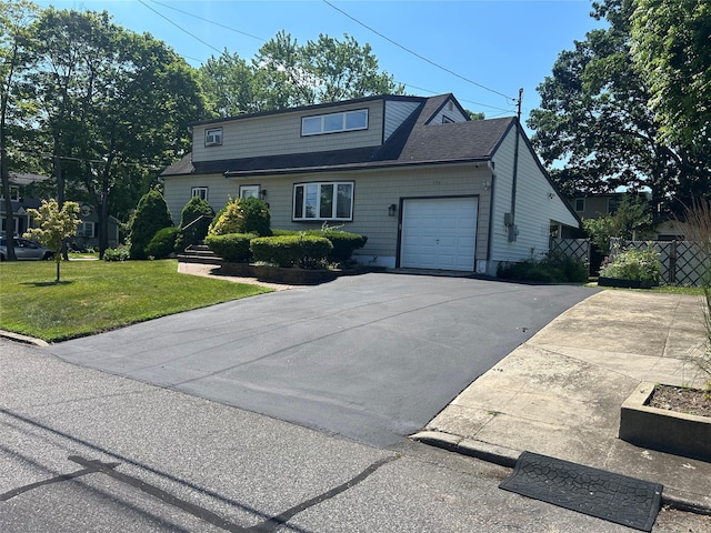 356 Montgomery Ave, West Babylon, NY 11704 - view of front of property featuring a garage and asphalt driveway