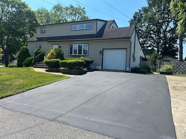 356 Montgomery Ave, West Babylon, NY 11704 - view of front of property featuring driveway, a garage, and a shingled roof