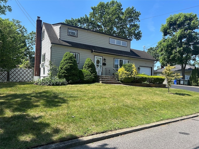 356 Montgomery Ave, West Babylon, NY 11704 - view of front facade featuring a chimney and an attached garage