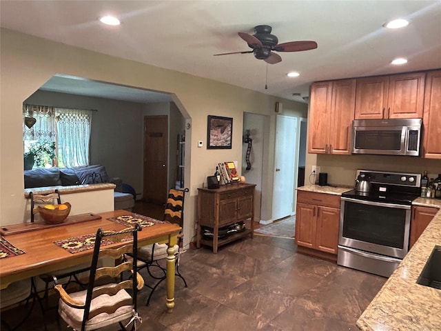 356 Montgomery Ave, West Babylon, NY 11704 - kitchen featuring appliances with stainless steel finishes, ceiling fan, arched walkways, recessed lighting, and brown cabinetry