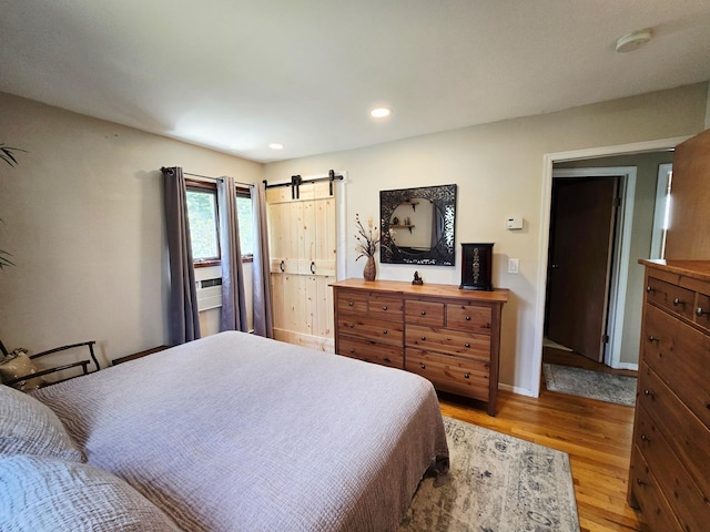 356 Montgomery Ave, West Babylon, NY 11704 - bedroom featuring light wood-style flooring, a barn door, and recessed lighting