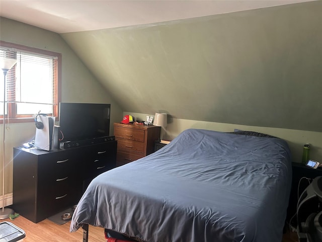 356 Montgomery Ave, West Babylon, NY 11704 - bedroom featuring vaulted ceiling and light wood-style flooring