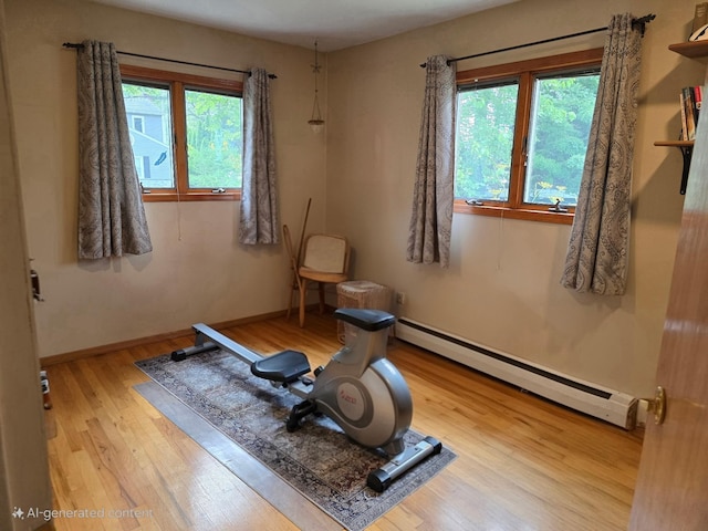 356 Montgomery Ave, West Babylon, NY 11704 - exercise area with baseboard heating, wood finished floors, and healthy amount of natural light