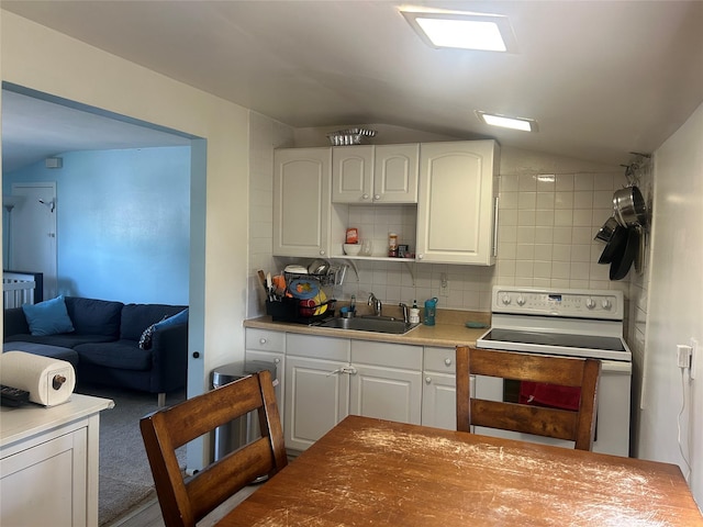 356 Montgomery Ave, West Babylon, NY 11704 - kitchen featuring white electric stove, lofted ceiling, tasteful backsplash, white cabinetry, and open shelves