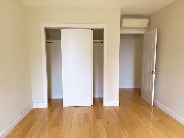 132-30 Sanford Ave Unit 4F, Flushing, NY 11355 - unfurnished bedroom with a wall unit AC, light wood finished floors, and a closet
