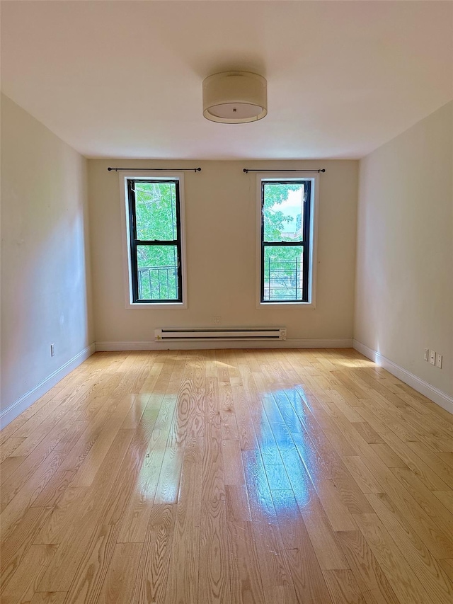 132-30 Sanford Ave Unit 4F, Flushing, NY 11355 - unfurnished room featuring baseboard heating and light wood-style flooring