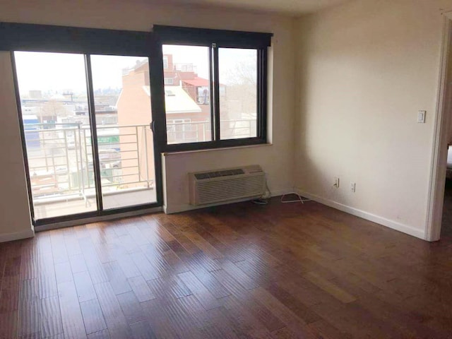 3138 137th St Unit 5A, Flushing, NY 11354 - unfurnished room with plenty of natural light, a wall unit AC, and wood finished floors