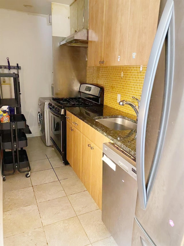 3138 137th St Unit 5A, Flushing, NY 11354 - kitchen featuring appliances with stainless steel finishes, separate washer and dryer, backsplash, dark stone countertops, and light tile patterned flooring