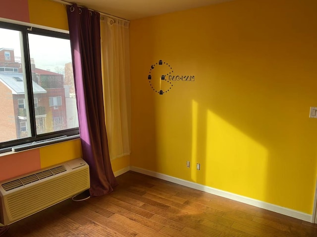3138 137th St Unit 5A, Flushing, NY 11354 - empty room with wood finished floors and a wall mounted air conditioner