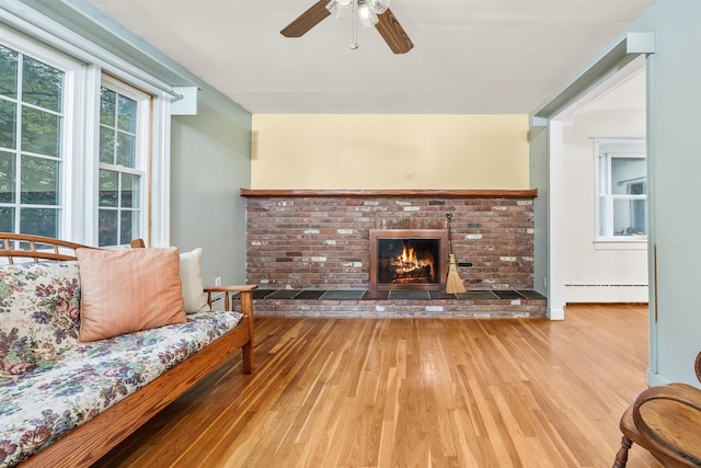 979 Duell Rd, Stanfordville, NY 12581 - living room with baseboard heating, hardwood / wood-style flooring, a ceiling fan, and a fireplace