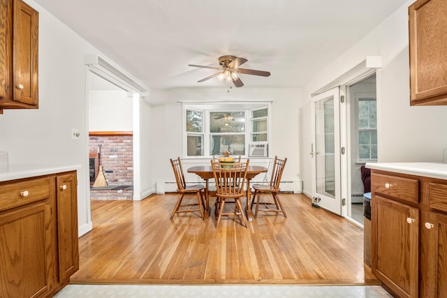 979 Duell Rd, Stanfordville, NY 12581 - dining room featuring light wood-style floors, a ceiling fan, and a baseboard heating unit