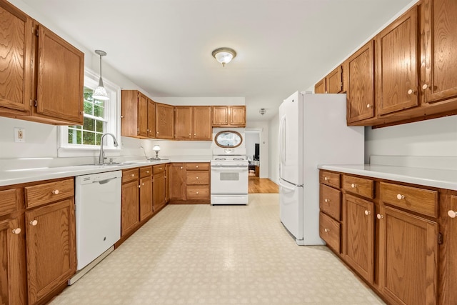 979 Duell Rd, Stanfordville, NY 12581 - kitchen featuring white appliances, light flooring, brown cabinets, light countertops, and decorative light fixtures