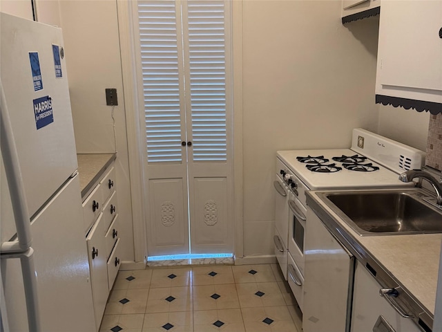 3530 Henry Hudson Pkwy Unit 1B, Bronx, NY 10463 - kitchen featuring white appliances, light tile patterned flooring, white cabinets, and light countertops