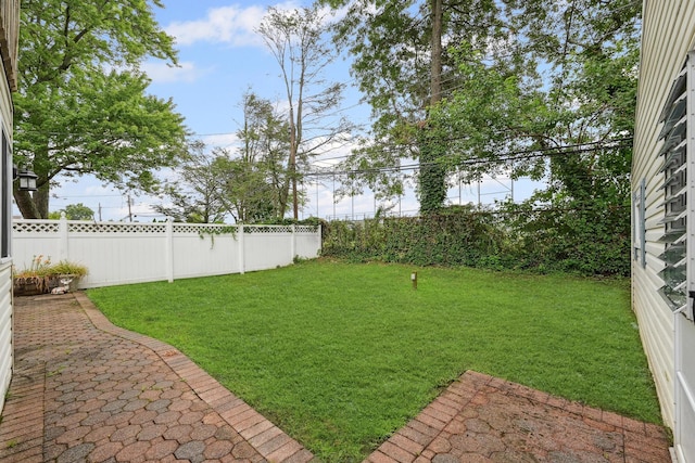 129 Spring Ln, Levittown, NY 11756 - fenced backyard with a patio