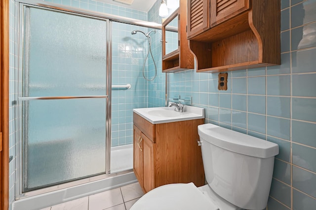 129 Spring Ln, Levittown, NY 11756 - bathroom featuring a stall shower, vanity, tile walls, tasteful backsplash, and tile patterned floors