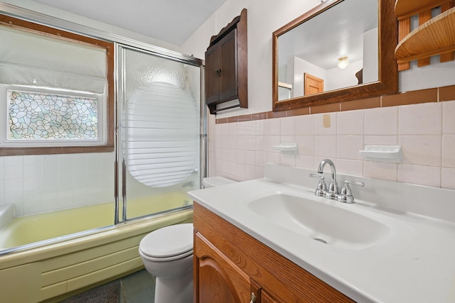 129 Spring Ln, Levittown, NY 11756 - full bathroom featuring vanity, tile walls, and enclosed tub / shower combo
