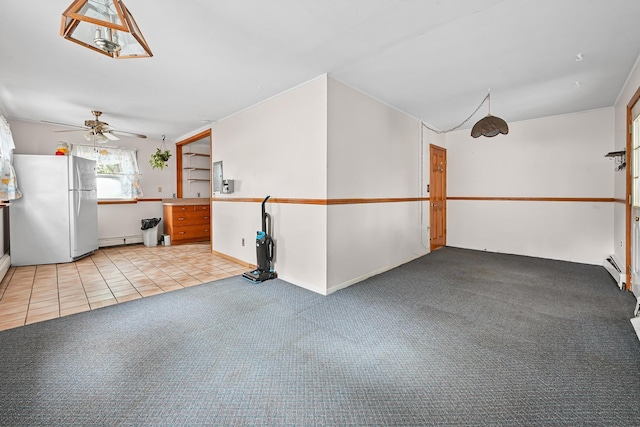 129 Spring Ln, Levittown, NY 11756 - garage featuring freestanding refrigerator, a ceiling fan, and a baseboard heating unit