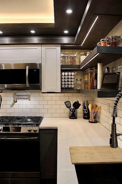 6 Devon Ct, Nanuet, NY 10954 - kitchen with appliances with stainless steel finishes, decorative backsplash, a raised ceiling, light countertops, and open shelves
