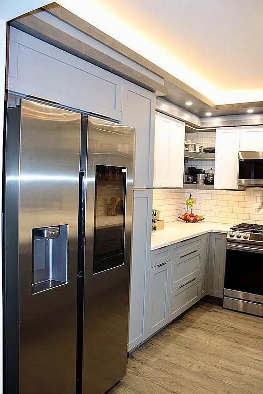 6 Devon Ct, Nanuet, NY 10954 - kitchen with stainless steel appliances, open shelves, gray cabinets, backsplash, and wood finished floors