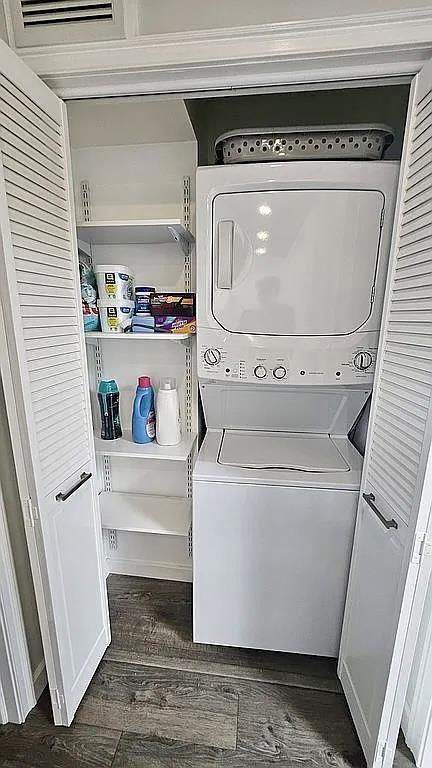 6 Devon Ct, Nanuet, NY 10954 - laundry room with stacked washing machine and dryer and dark wood-style floors
